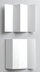 Top-down view of two unfolded, blank white brochures on a grey surface