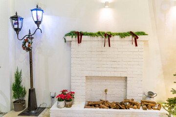 A charming Christmas setup featuring a Santa Claus figurine surrounded by small festive decorations and wrapped presents. The scene highlights warm holiday cheer with miniature ornaments, gift boxes, 