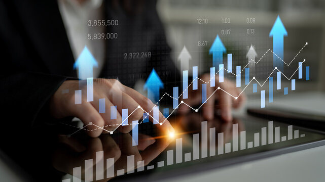 Business professional interacts with digital graphs and charts on tablet, showcasing financial trends and market growth in contemporary workspace setting. Scalp - Powered by Adobe