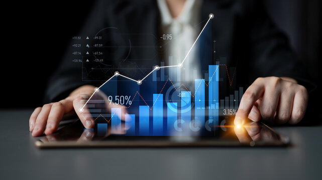 A business professional analyzing financial data trends with a tablet, showcasing visual graphs and metrics, representing modern financial analytics in a corporate environment. Scalp