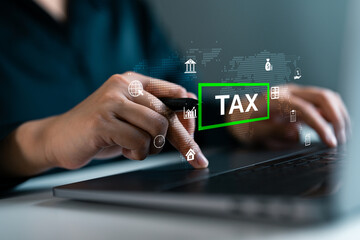 Close-up of hands using laptop with digital TAX, featuring finance and accounting icons. Ideal for content on online tax filing, finance management and digital accounting systems.