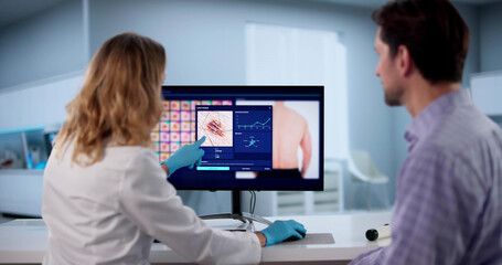 Dermatologist Performs Digital Skin Screening For Melanoma