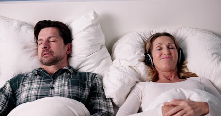 Frustrated Woman Uses Headphones To Block Loud Snoring