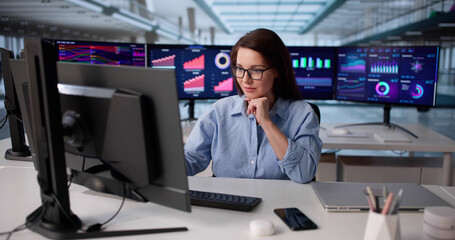 Focused Businesswoman Analyzing Financial Charts