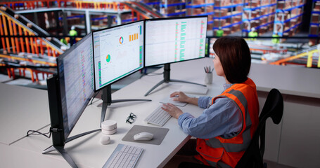 Female Warehouse Operator Using Computer Software