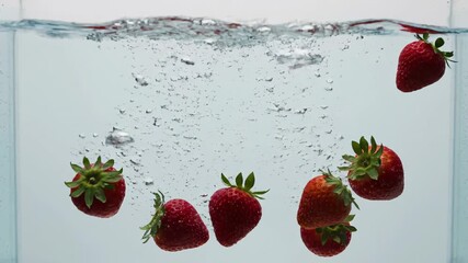 Strawberry Splash in Water: A vibrant display of ripe strawberries submerged in clear water, creating a dynamic splash with bubbles and the play of light.