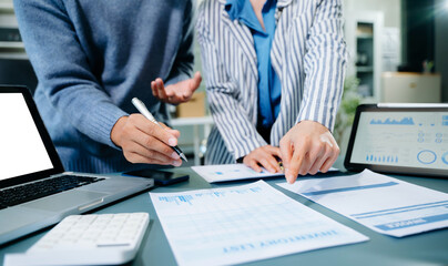 Two young businesswomen working new start up project Laptop computer and digital tablet and smart phone and discussing business plan. At office