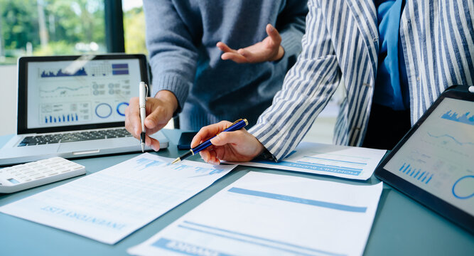 Two young businesswomen working new start up project Laptop computer and digital tablet and smart phone and discussing business plan. At office
