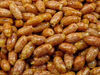  Sai Krok Isan (Thai e-san sausage), a popular street food from Northeastern Thailand. Close-up, overhead view. 