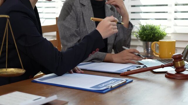 Lawyers and business professionals discuss contract papers at the office. legal and corporate consultation concept focusing on law, advice, and business agreements.