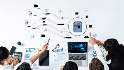A diverse business team collaborates over data analysis with charts and documents, showcasing effective teamwork in a modern office environment. Trope