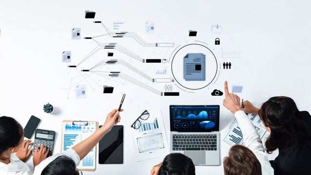 A diverse business team collaborates over data analysis with charts and documents, showcasing effective teamwork in a modern office environment. Trope