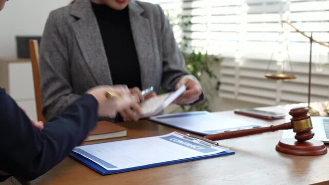 Teamwork of business lawyer meeting working hard about legal legislation in courtroom to help their customer.