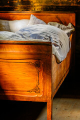 Cozy bed with checkered pillows in a rustic wooden cabin during a serene afternoon