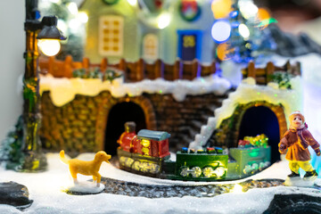 A beautifully crafted Christmas music box featuring reindeer, Santa figures, festive dolls, and a rotating carousel. The intricate design, warm lighting, and nostalgic holiday motifs create a magical 