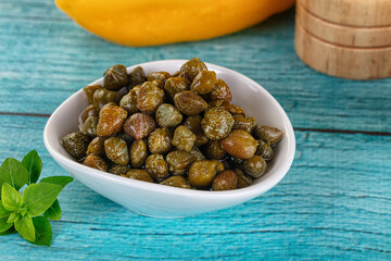 Pickled canned capers in the bowl