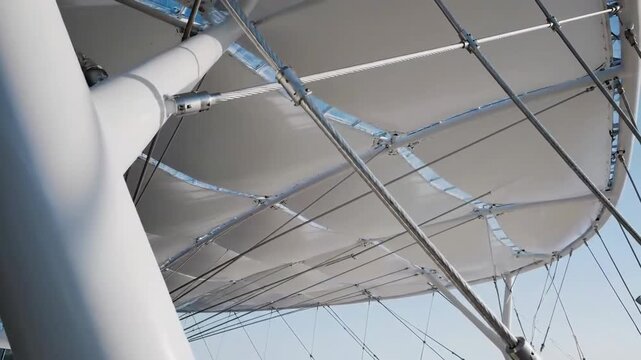 Architectural Marvel: Modern Canopy Design Structure Against a Bright Blue Sky