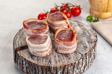 Raw pork tenferloin with bacon