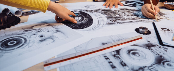A dynamic scene of engineers collaborating on intricate technical drawings and blueprints,...