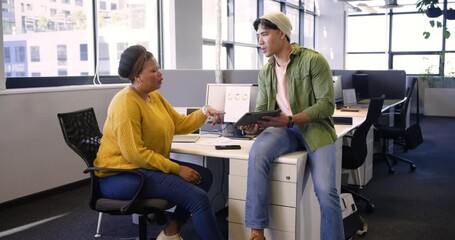 Triggered by tablet chart, diverse coworkers reviewing data on laptop and tablet to refine plan - Powered by Adobe
