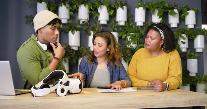 Diverse coworkers sliding sheet sparking review at table leaning pointing tapping for consensus