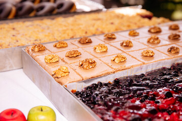 Assorted desserts with walnuts and berries at a buffet