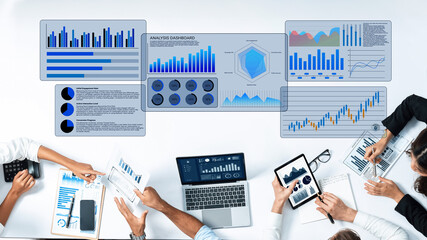 A group of professionals collaboratively analyzing data insights using various digital devices in a modern office setting, emphasizing teamwork and strategic planning. Gantry