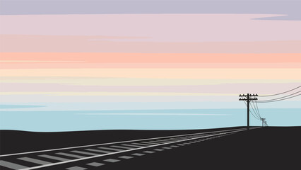 Railway tracks stretching towards the horizon with a utility pole.