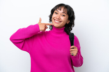 Young Argentinian singer woman isolated on white background giving a thumbs up gesture