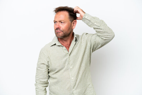Middle age caucasian man isolated on white background having doubts while scratching head