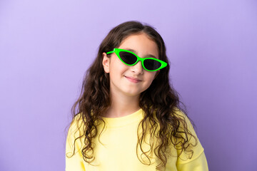 Little caucasian girl isolated on purple background