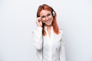 Fototapeta premium Telemarketer Russian girl working with a headset isolated on white background with glasses and happy