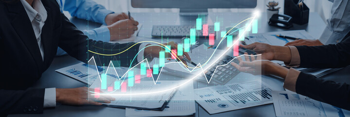 A business team collaborates to analyze financial data using modern digital graphs and charts, showcasing insights for effective decision-making and growth strategies. Axiom