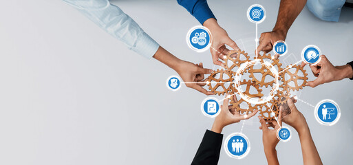 A diverse group of hands working together around interconnected gears, symbolizing collaboration...