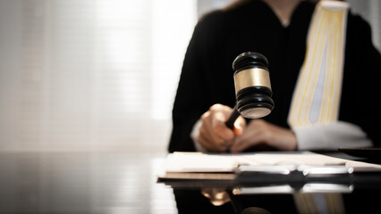 A judge raises gavel in courtroom, poised to deliver formal ruling, global justice, international law, digital regulation, modern legal authority across criminal, trade, cyber, humanitarian fields.