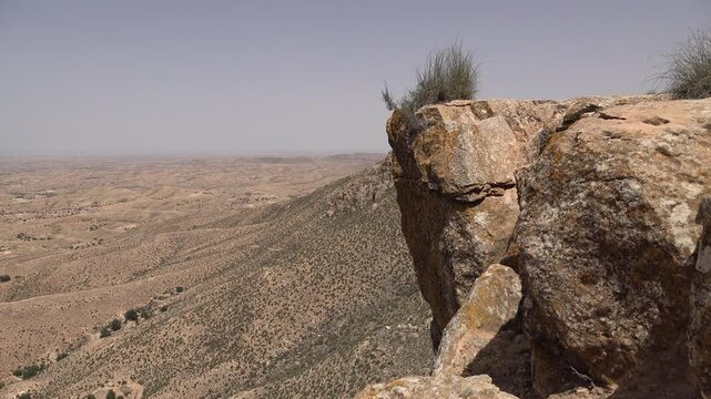 Rock formations and arid desert landscape in Matmata region in Tunisia
