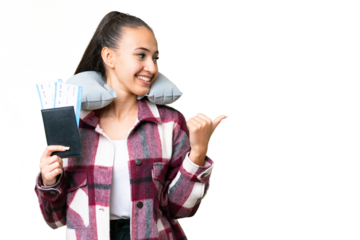 Young Traveler woman holding a passport over isolated chroma key background pointing to the side to present a product