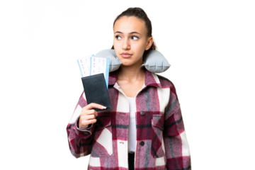 Young Traveler woman holding a passport over isolated chroma key background looking to the side