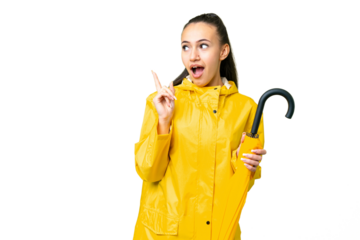 Young Arabian woman with rainproof coat and umbrella over isolated chroma key background intending to realizes the solution while lifting a finger up