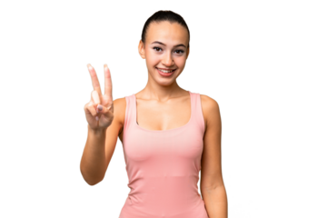 Young Arab woman over isolated background smiling and showing victory sign