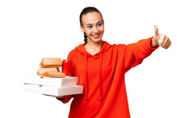Young Arab woman holding fast food over isolated background giving a thumbs up gesture