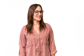 Middle-aged caucasian woman over isolated background looking to the side and smiling
