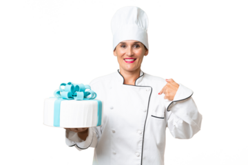 Middle-aged chef caucasian woman with a big cake over isolated background with surprise facial expression