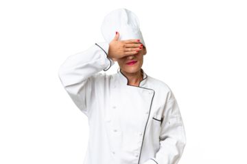 Middle-aged chef woman over isolated background covering eyes by hands. Do not want to see something