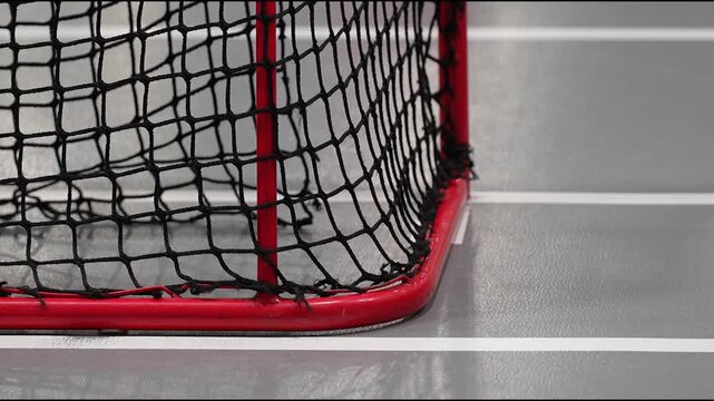Valmiera, Latvia - December 03, 2025: Floorball goal net close-up, camera zooms in on details, showcasing action and intensity in sports environment