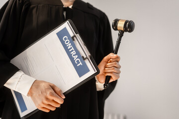 A professional legal authority in black robe holds a contract clipboard, expertise in international trade, cybersecurity regulations, data protection compliance, global humanitarian justice systems.