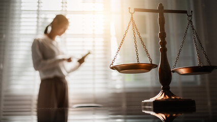 The scales of justice stand in focus while a woman seeks counsel, symbolizing the legal protection of women's rights, gender equality, safety from domestic violence, and the pursuit of fair justice.