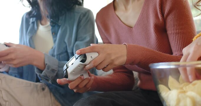 Right friend is adjusting grip, causing both pressing controllers, grabbing chips, continuing play