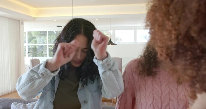 Camera pulling back revealing female friends at home, dancer lifting tapping friend joining dance