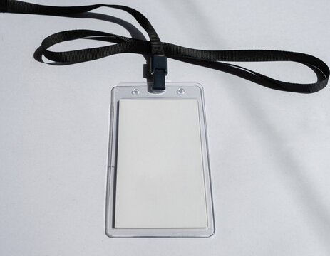 Blank ID card and badge with a USB flash drive and cables on a white background